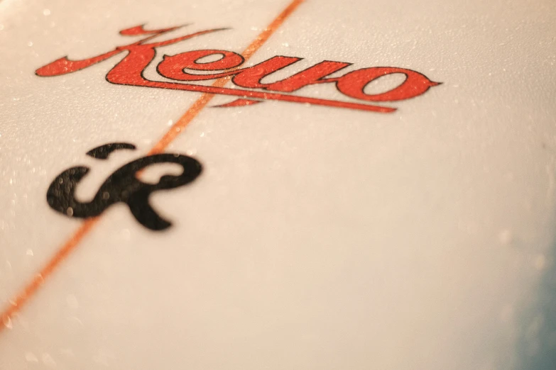 a close up of a surf board with the word kenzo on it