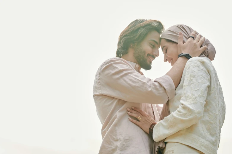 two people dressed in white emce one is holding his hand around the other