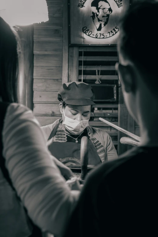 a woman in a restaurant with a mask on