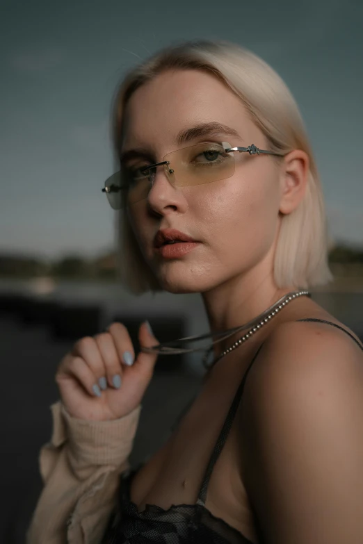 woman wearing glasses while standing on the side of the road