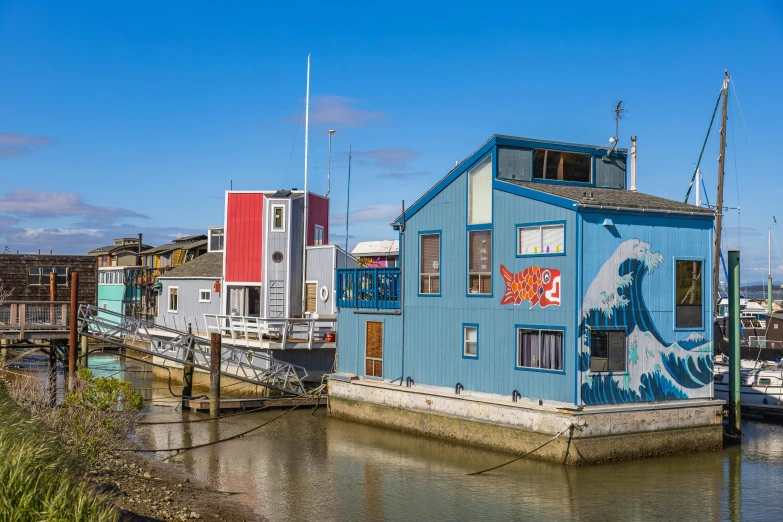 an image of blue house boat on water