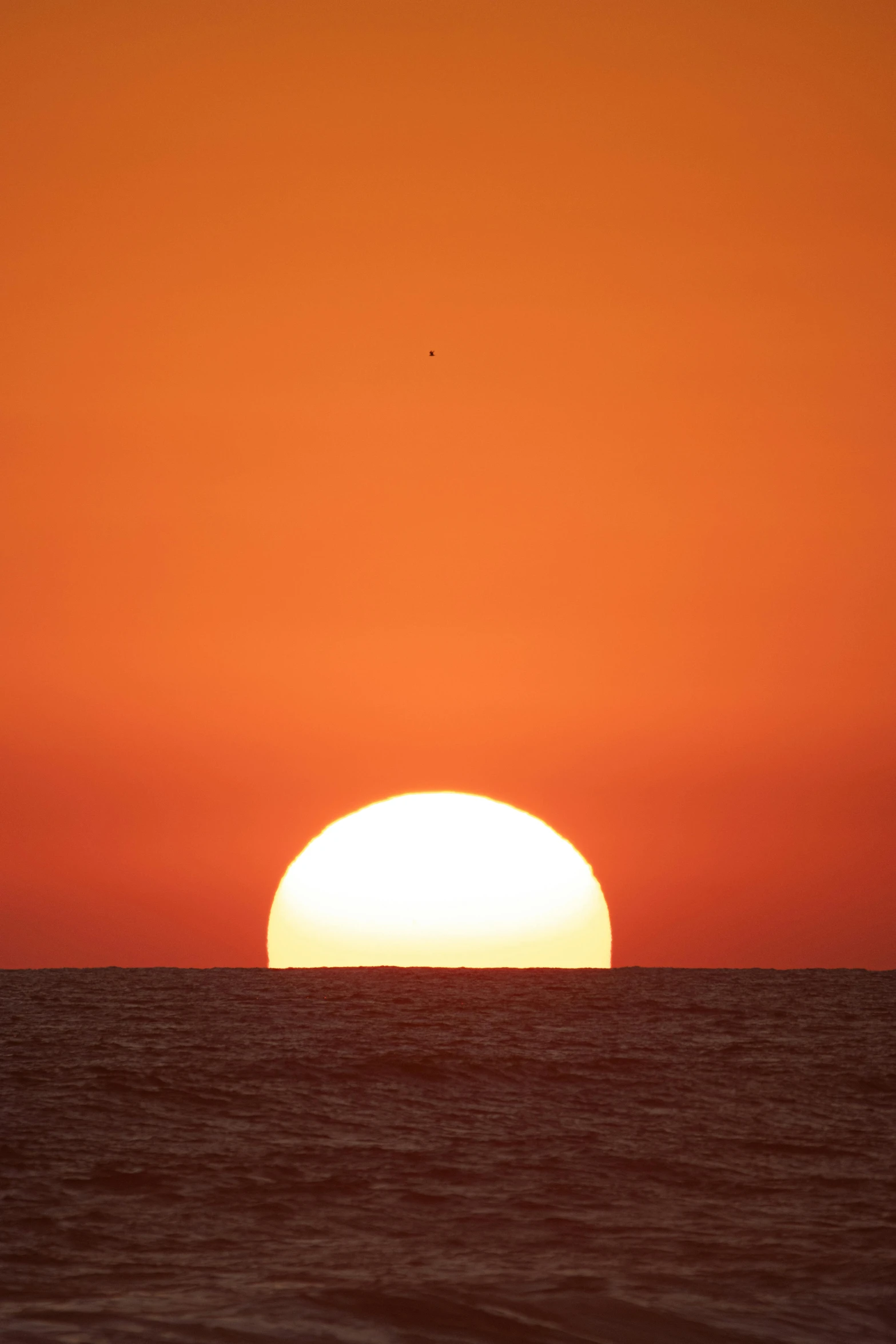 the sun is setting over the ocean and horizon