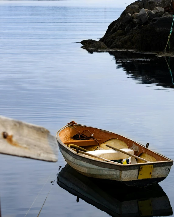 there is a row boat floating on the water