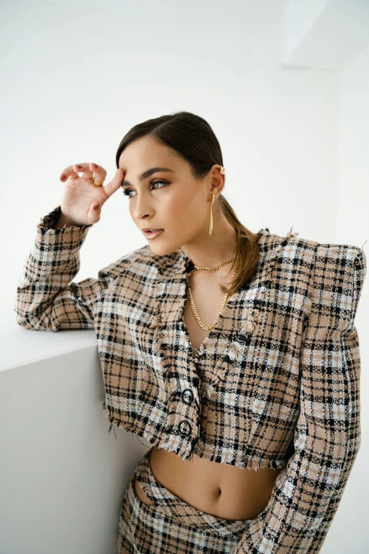 a woman with long hair and earrings on her left arm