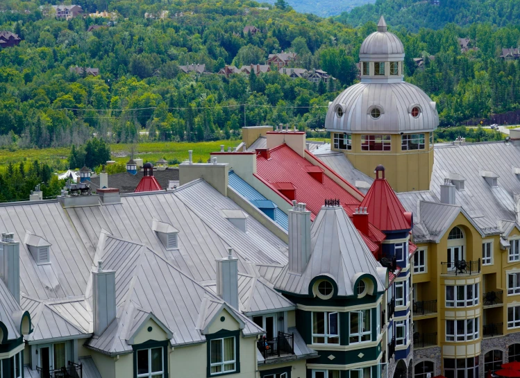 many different colored houses with mountains in the background