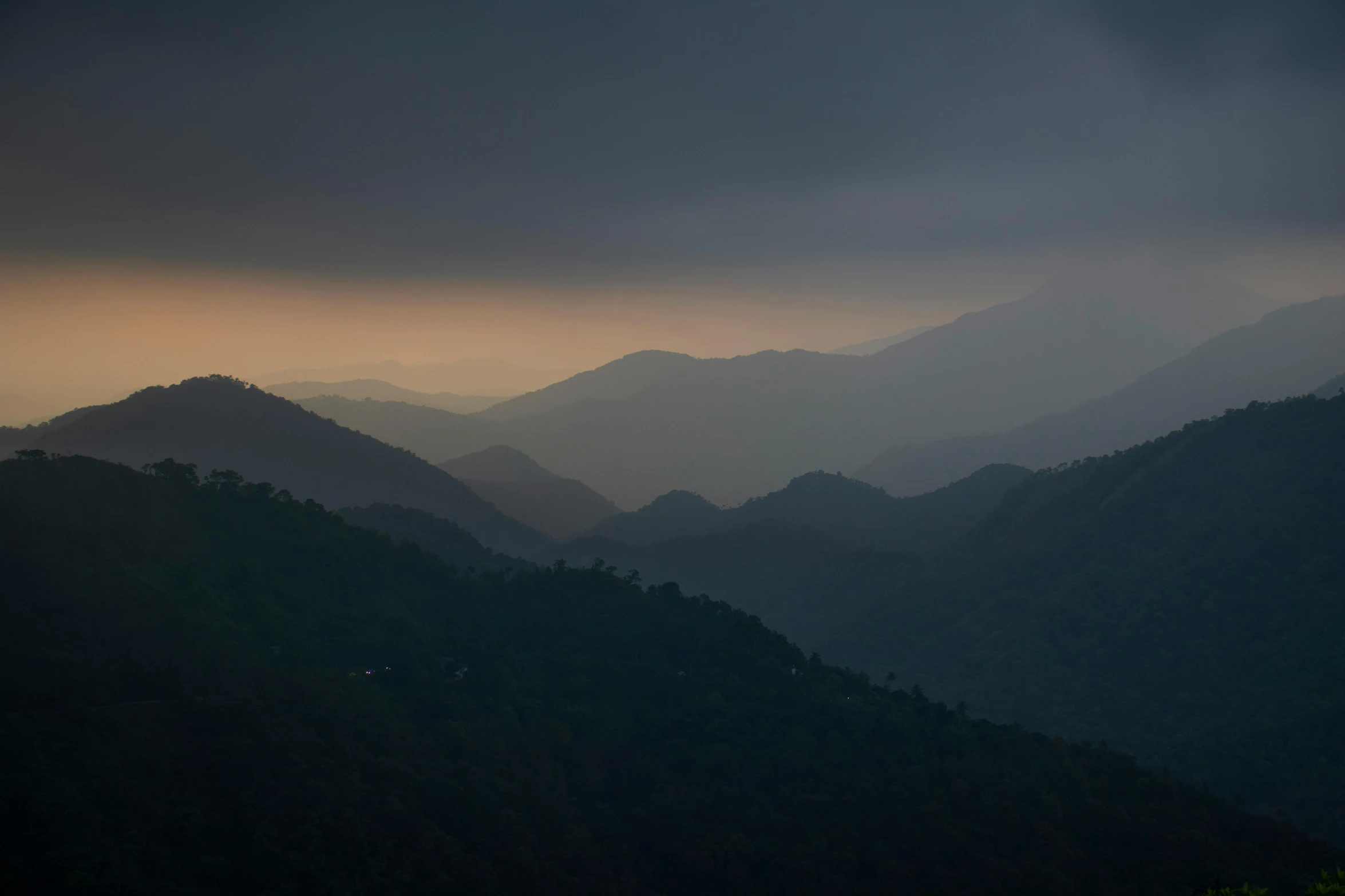 the sky is darkened over a landscape with mountains