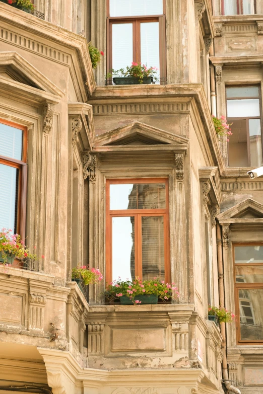 an old building has flower boxes on the balconies