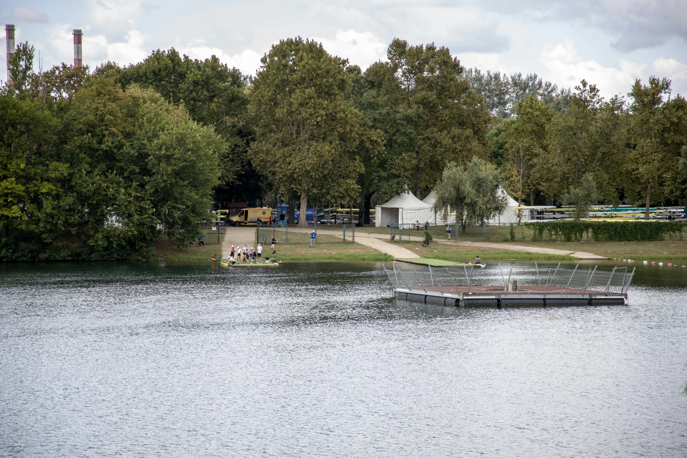 a small boat is floating down a lake