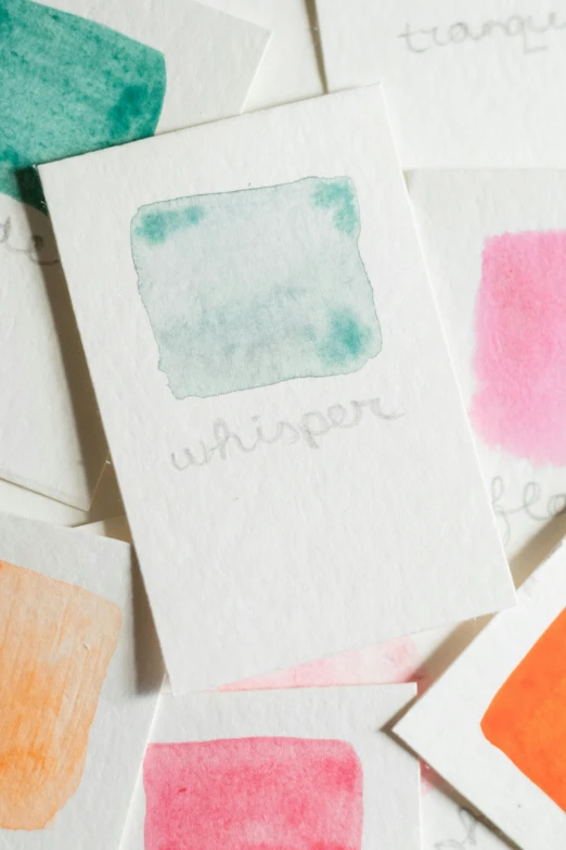 an array of different colored paper with the words watercolor