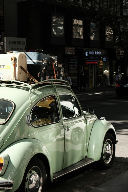 a car with luggage on top is parked on the street