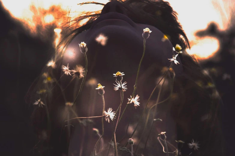 the woman is standing in a field of wildflowers