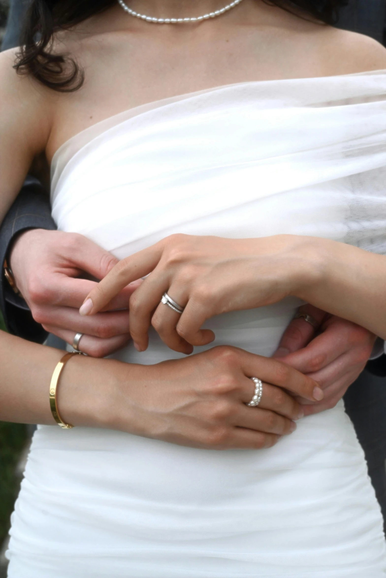 a close up of a couple holding hands with rings