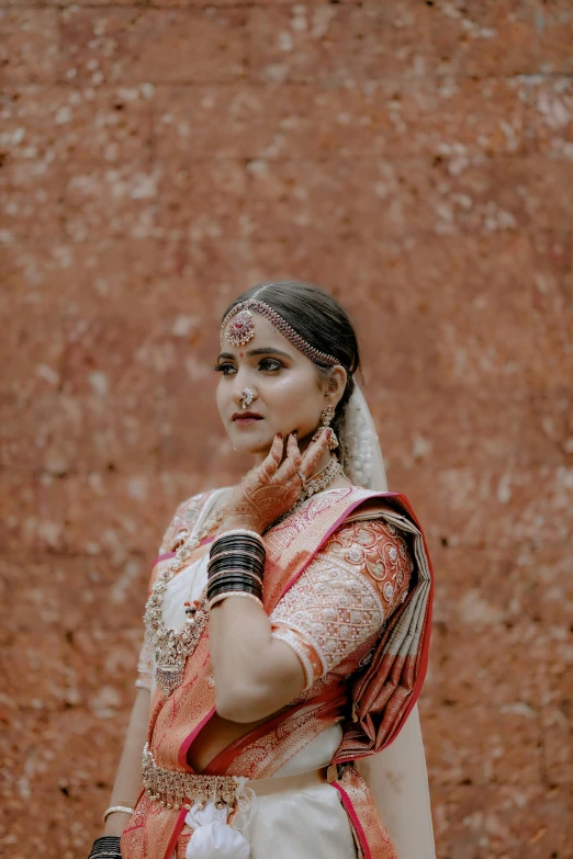 a woman in a white sari with a necklace on