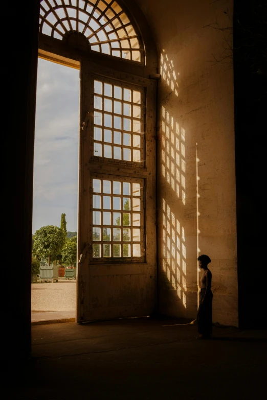 an open door with the shadow of a person in the middle