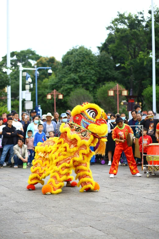 a couple of people standing in front of a lion dance