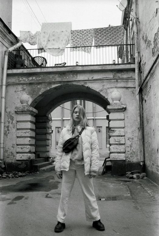 a girl is standing alone in the street