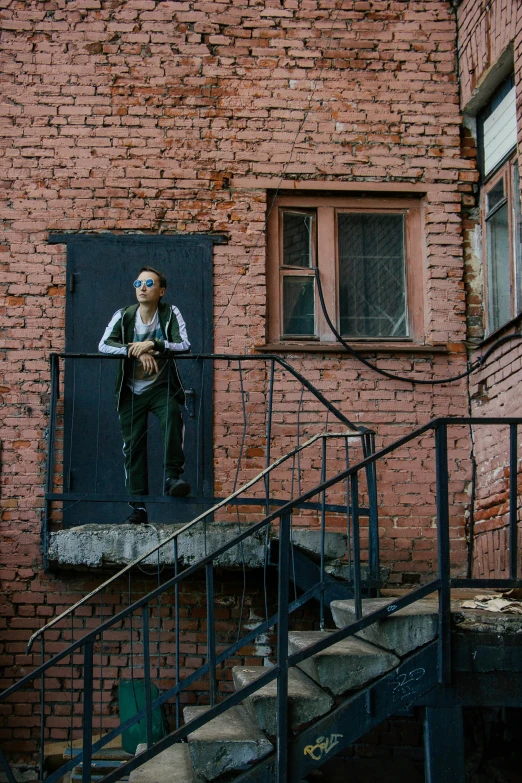 a mural on the side of a brick building with a man's reflection