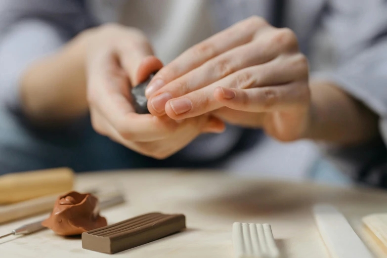 someone holding a phone at a table with items on it