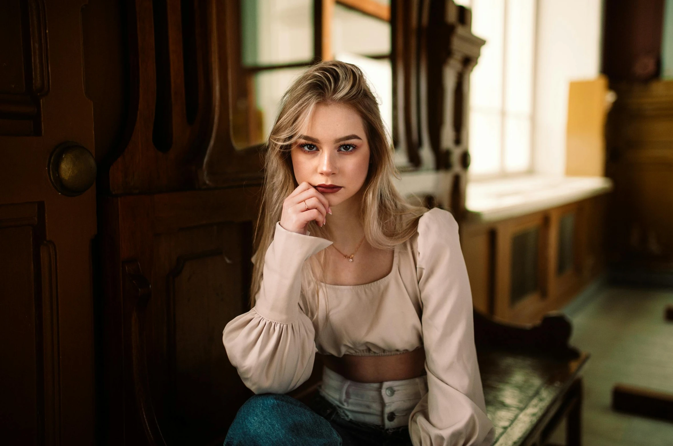 the beautiful young woman in the chair poses for the camera