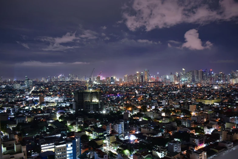 a night view of a cityscape of skyscrs and lights