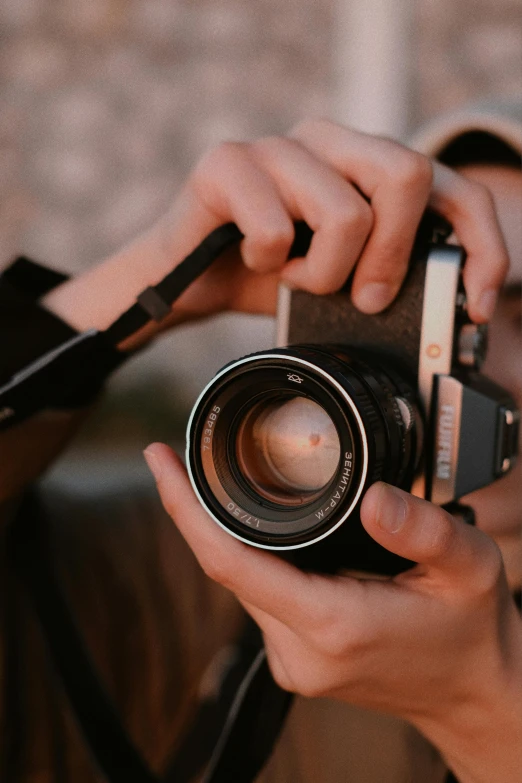 person holding a small camera while taking a po