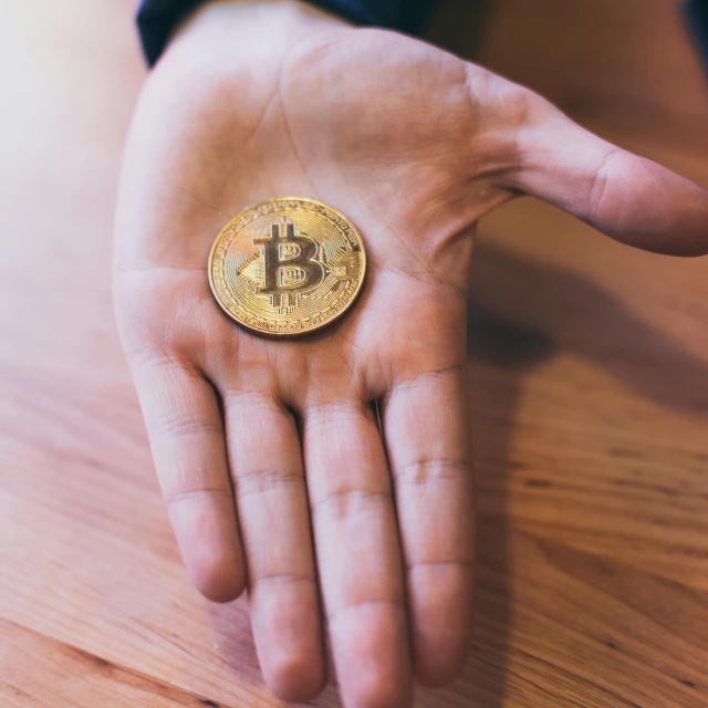 a close up of a person holding a coin