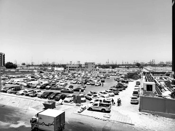 a parking lot full of cars and trucks