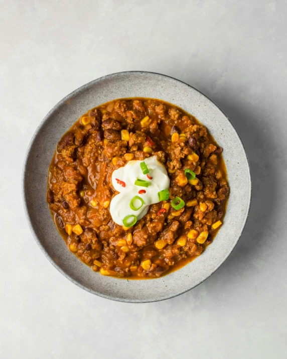 bowl of chili and corn topped with sour cream