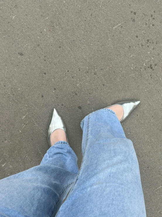 the feet of a woman wearing high heeled white shoes