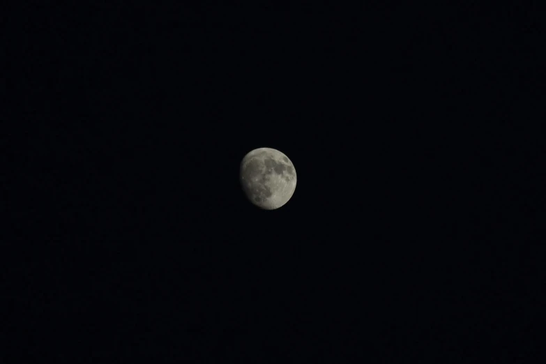 a night scene with a half moon in the dark sky