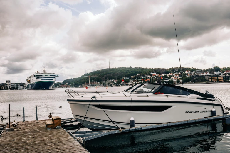 a motorboat sits in a body of water near a pier