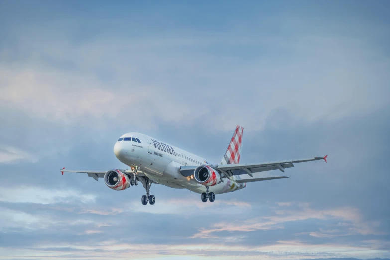 an airplane flying in the air at the airport