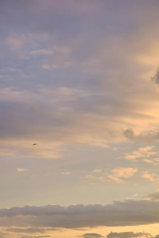 two airplanes are flying in the sky and it's sunset