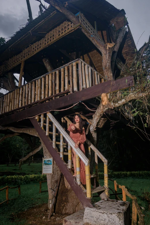 a woman standing on top of wooden steps