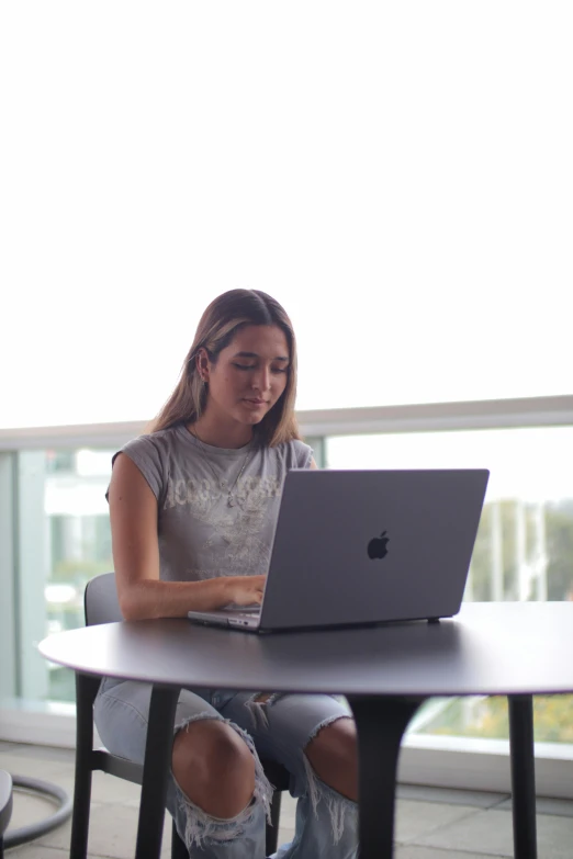 a young woman uses her laptop on the desk