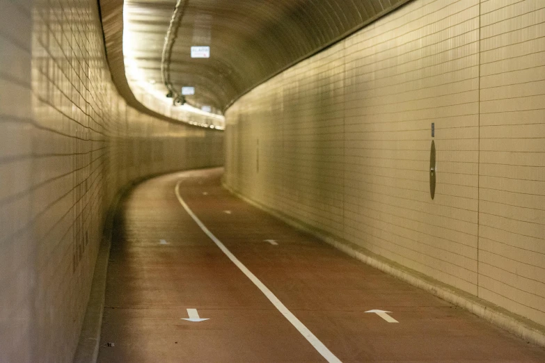 the view down a tunnel with a person wearing black