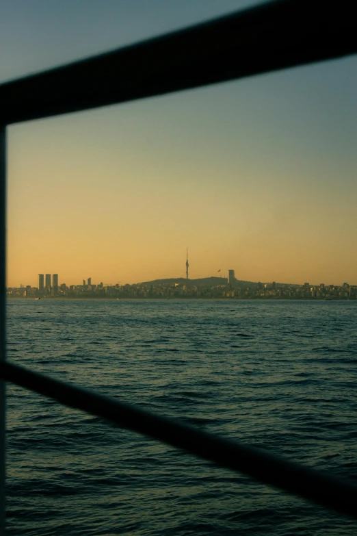 a big city seen over the water at sunset