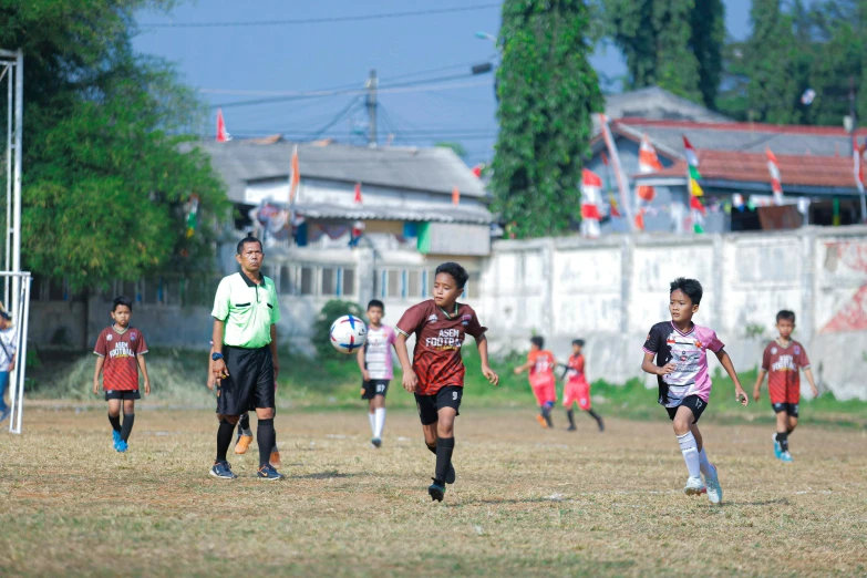 a group of s playing soccer on a grass field