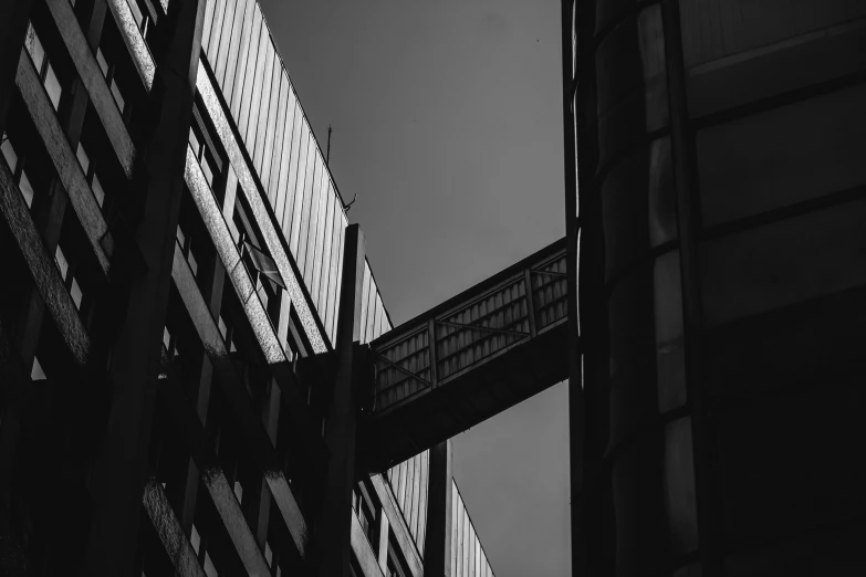 a tall building with lots of windows and a bridge across it