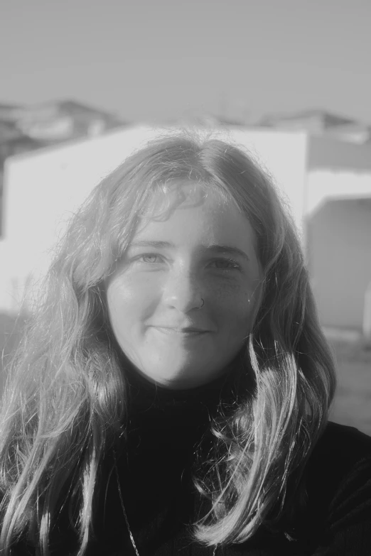 a black and white po of a woman smiling for a picture