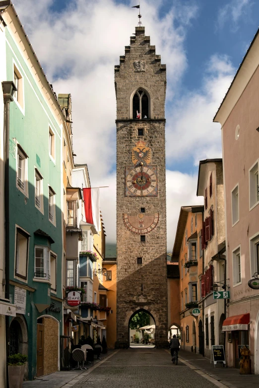 a stone clock tower sitting between two buildings