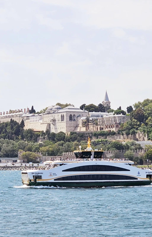 a boat traveling down a river next to a city