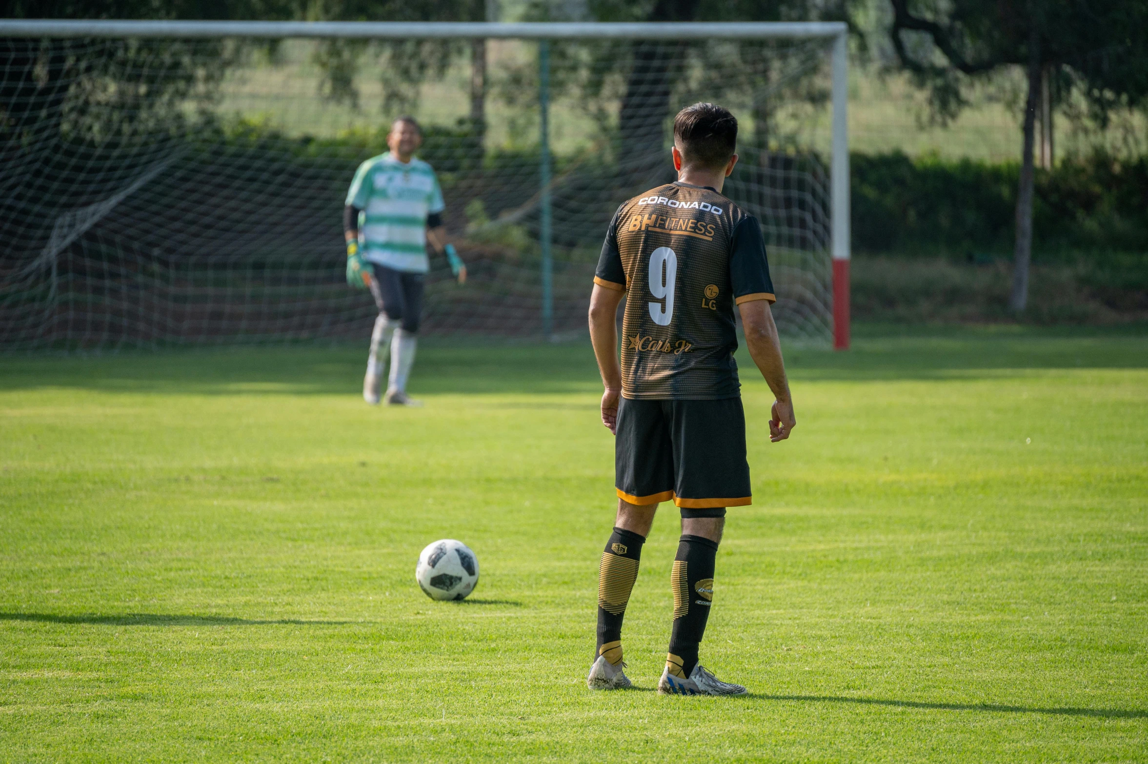 two men are playing soccer on a field