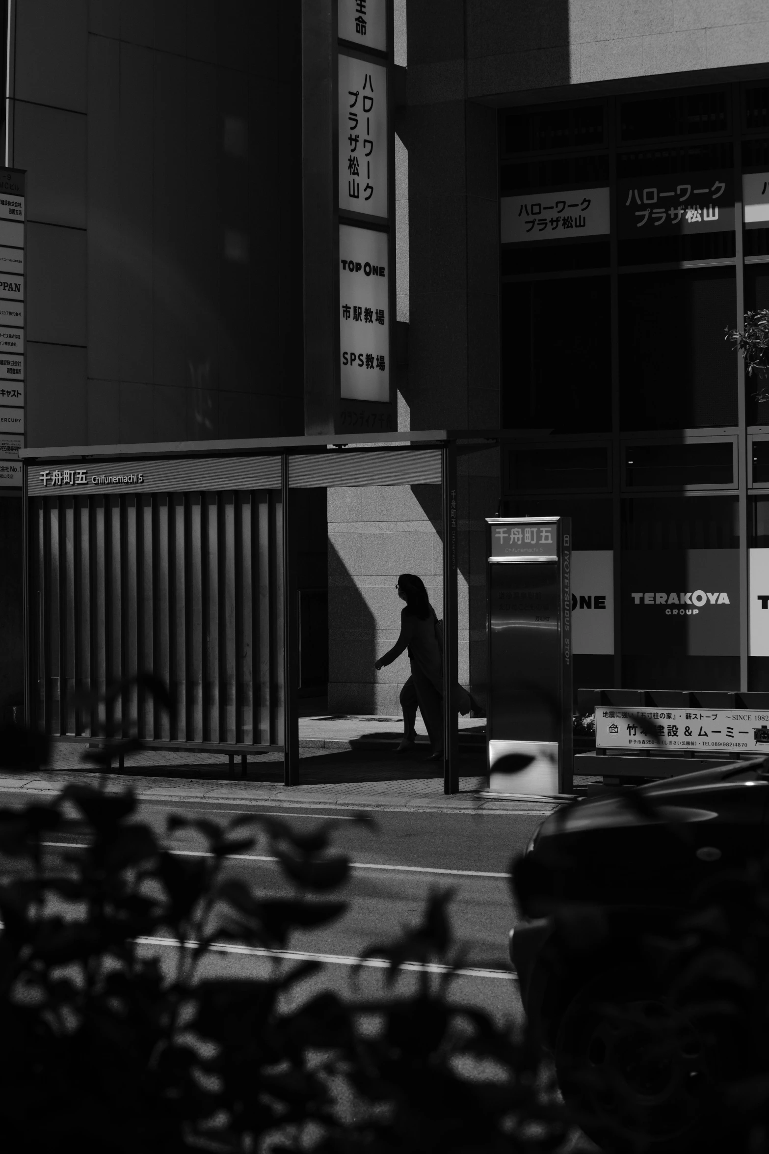 a person walking across the street in front of a building