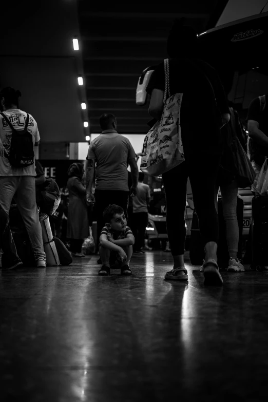 a group of people waiting for their luggage at the airport