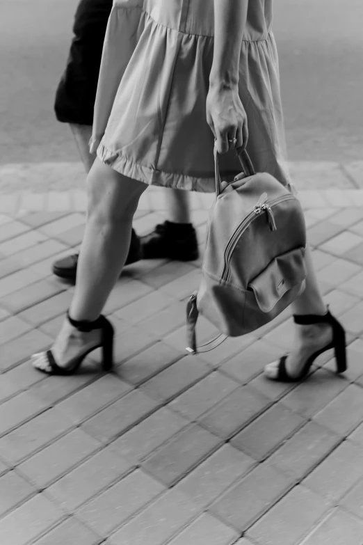 a woman with a purse is seen walking