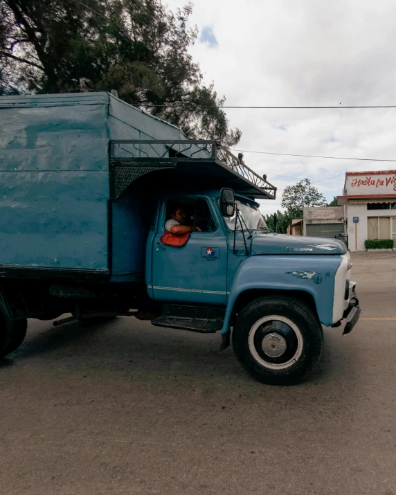 the blue truck is parked in a parking lot