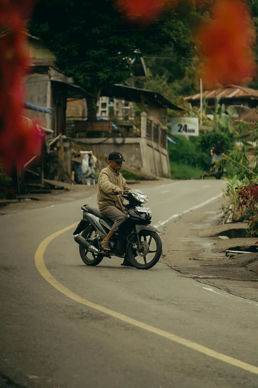 a man riding a motorcycle down the street