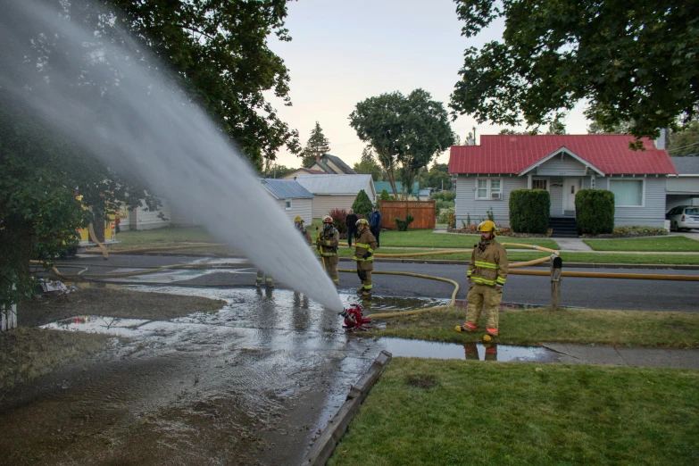 firemen doing a house fire on a residential street