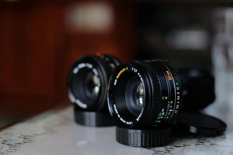 two large camera lenses sitting on top of a table